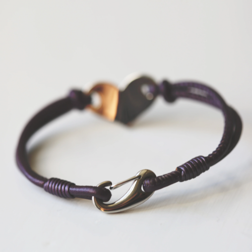 Purple bracelet with a silver clasp on a light background